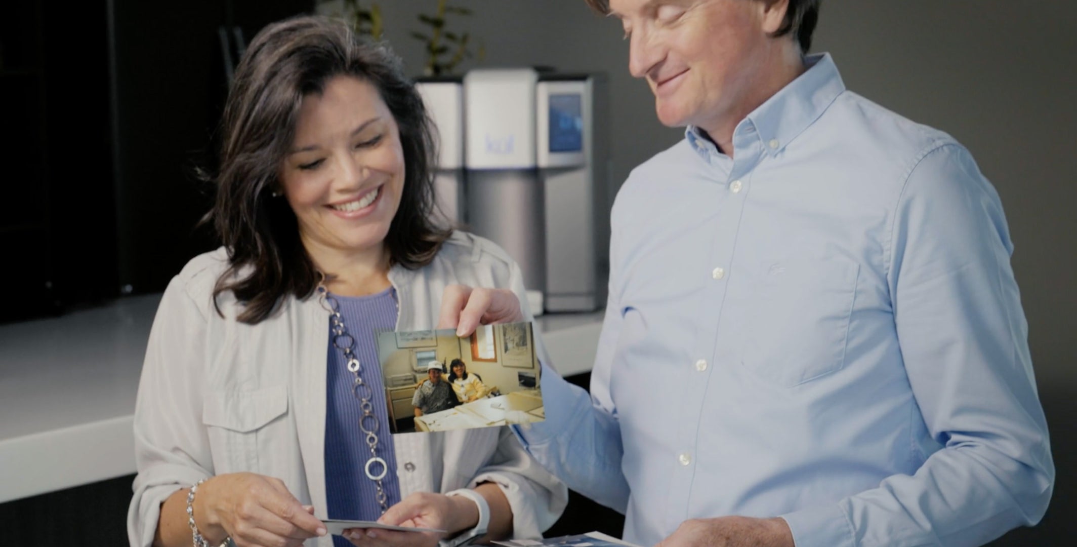 Couple looking at old photo of each other