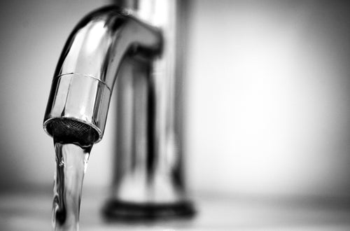 Silver faucet with running water